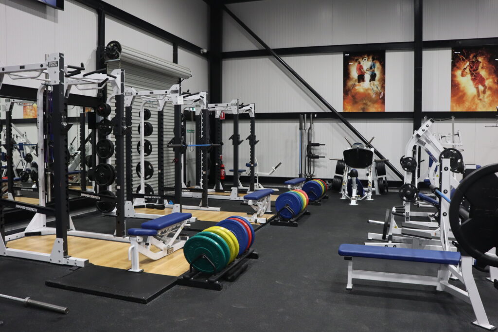 The main gym area at CountryFit Gym Mudgee features a variety of quality workout equipment, including weight benches, barbells, and cardio machines.